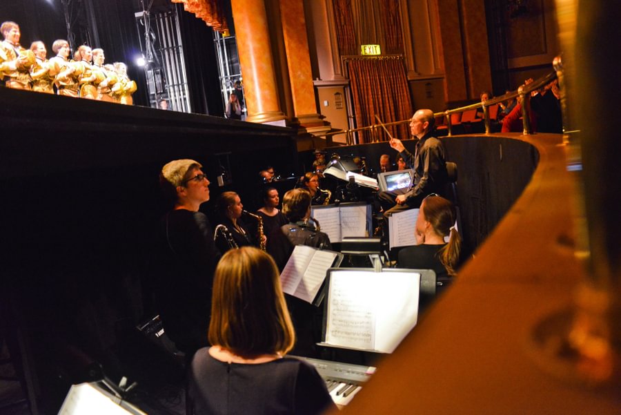 Music Prof. John “Buzz” Jones conducts the band during a showing of “A Chorus Line” at the Majestic Theater in 2013.