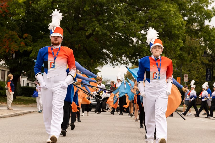 The Bullets Marching Band steps down the street on the way to the stadium during Homecoming Weekend