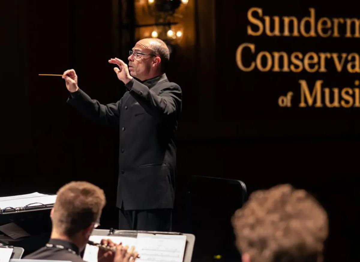 Russell McCutcheon conducting the Wind Symphony during the spring of 2023 