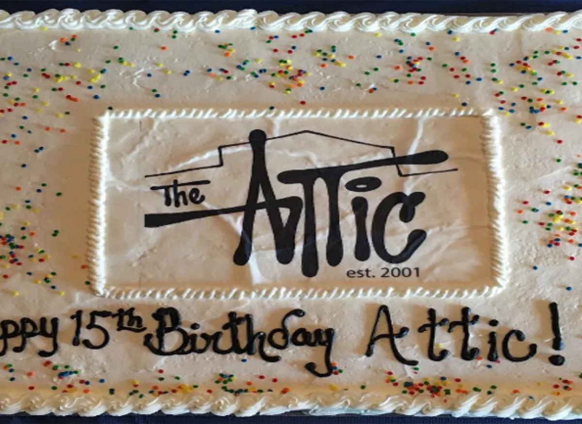 A cake with "Happy 15th Birthday Attic!" written on it.