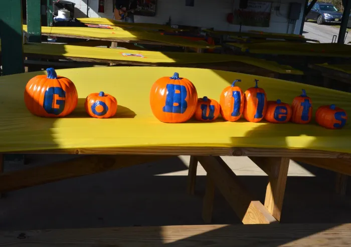 Pumpkins painted to read "Go Bullets" on a table at Quarry Pavilion.