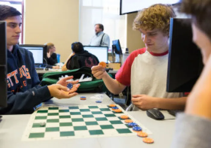Students play a strategy game in a classroom computer lab.