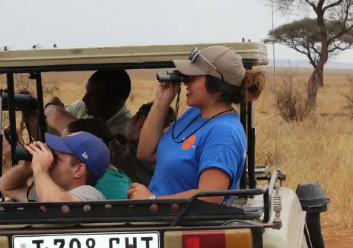 Students observe wildlife from a safari vehicle during a study-abroad field experience.