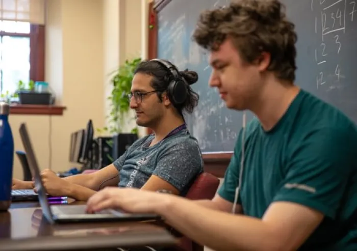 Two students working on their laptops