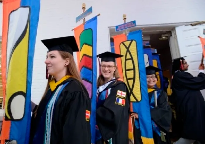 Graduates holding their departments banners