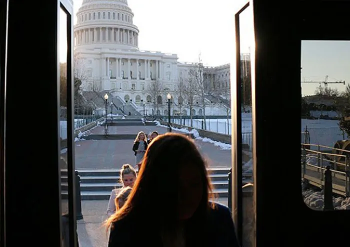 A woman looks toward the U.S. Capitol.