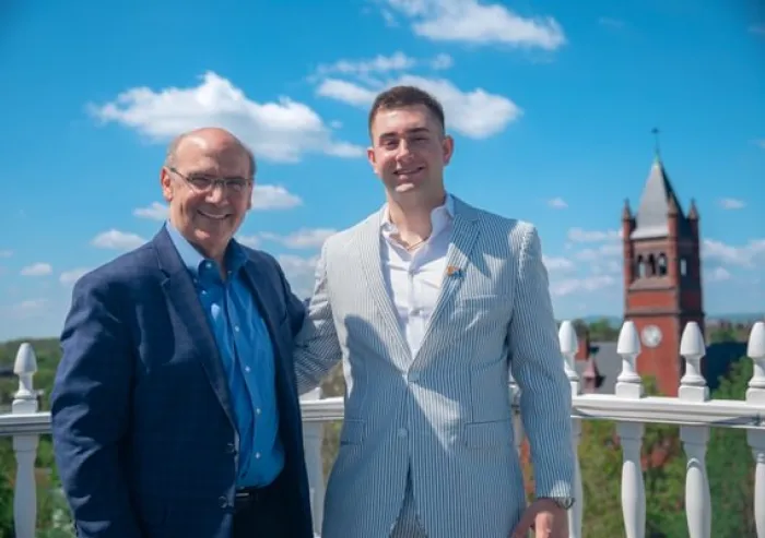 Bob with a student on a campus rooftop