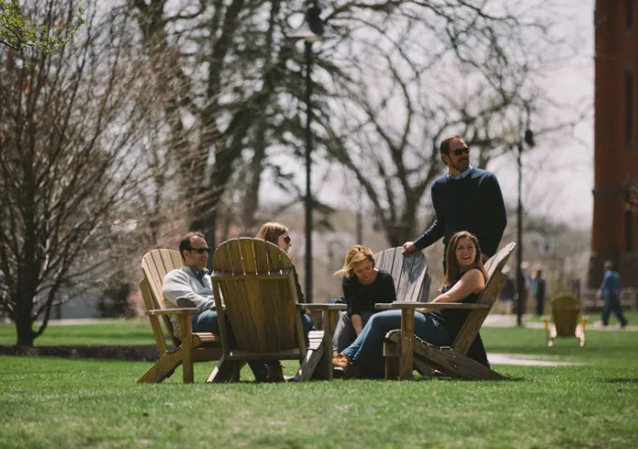 A group of parents sitting together on campus.