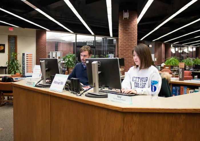 Students working at an information desk