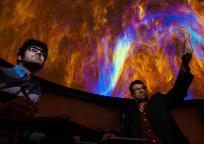 A student and faculty member at the Hatter Planetarium.