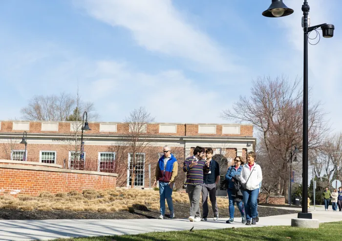 A group of people walking down the pathway