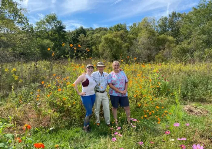 Three people in wildflower field