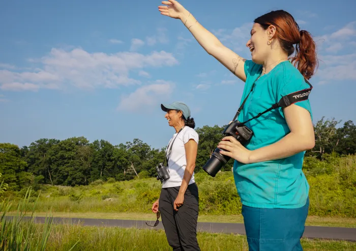 student and prof outside in field