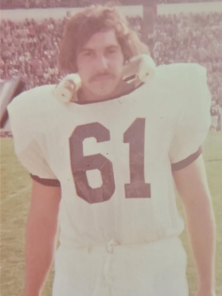 historical photo of football student-athlete in jersey with 61