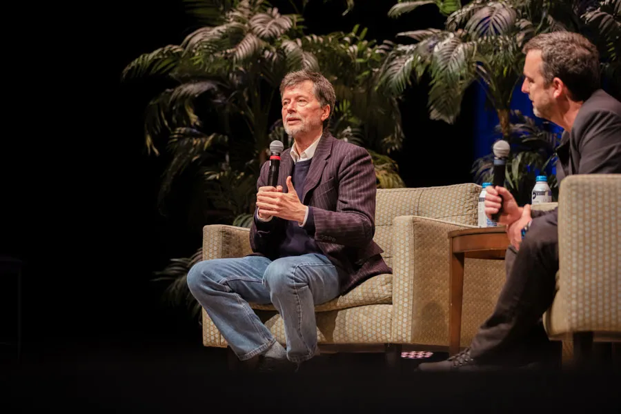 Ken Burns sitting down and speaking on stage