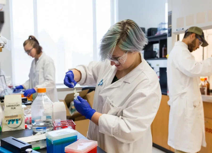 female student pipettes in chemistry lab