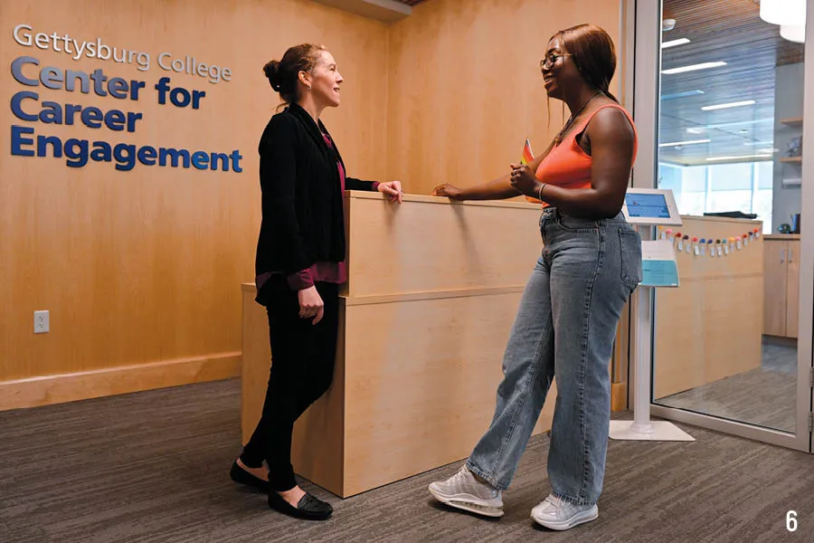 employee and student talk at center for career engagement welcome area