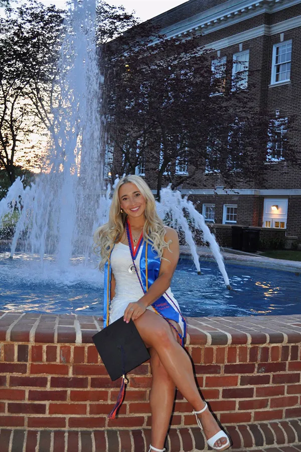 Giovanna Komst sits in front of fountain