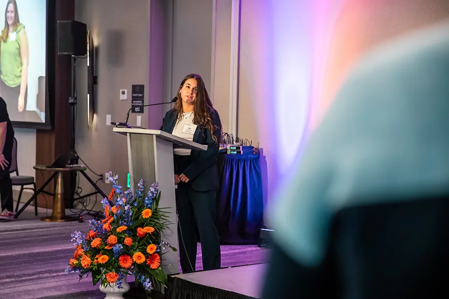 Ava Burchell ’25 emcees and speaks at the College’s reception.