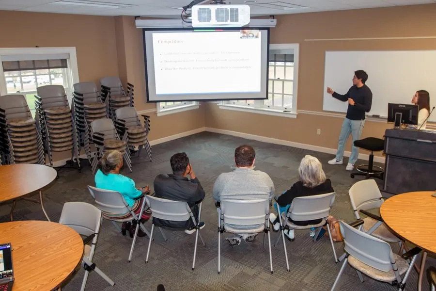 Sanij Shrestha ’26 and Sunny Ho ’27 deliver their proposal to a panel of business professionals