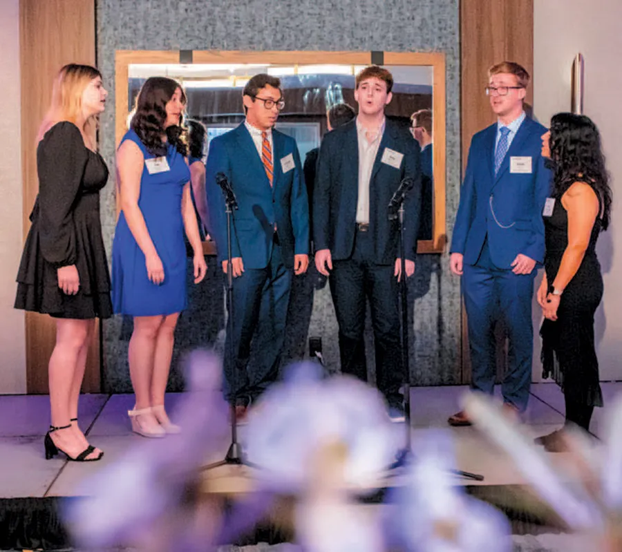 group of students sings together on stage
