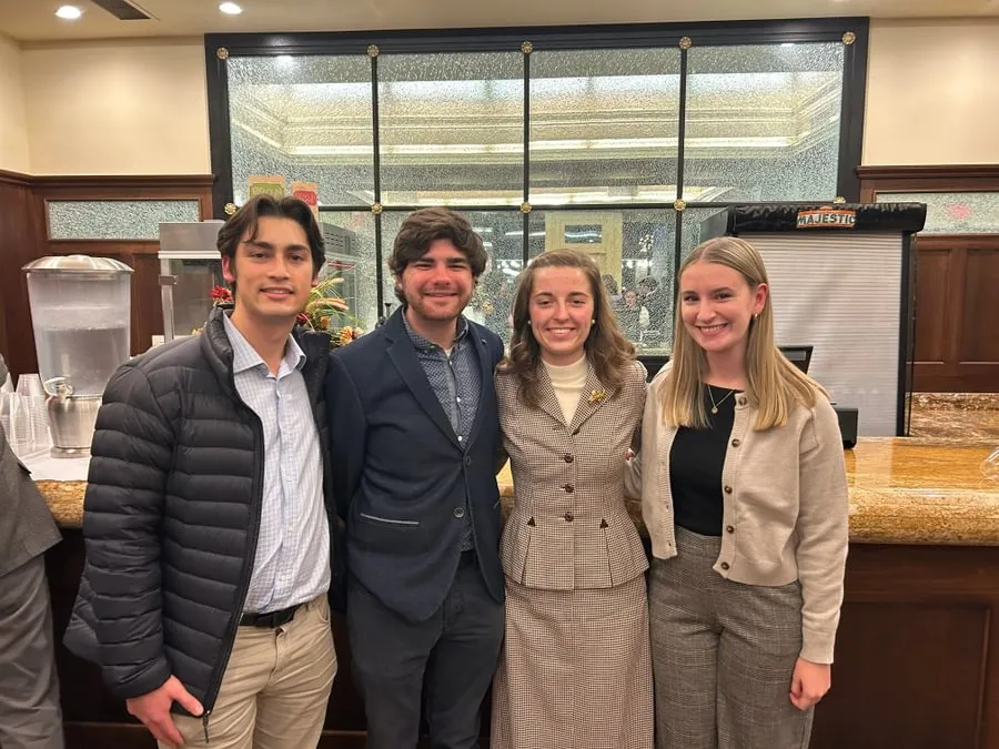 Strittmatter, Hayden McDonald ’25, Russell, and Maddie Ulman ’26 attending the Fortenbaugh Lecture inside the Majestic Theater.