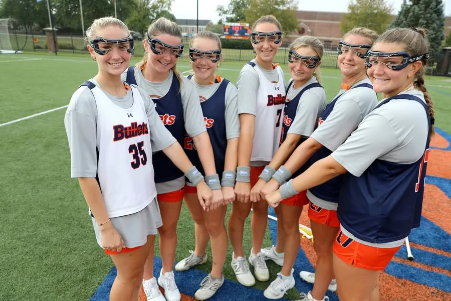 Women’s lacrosse Class of 2028 players show wristbands with Sadie Mauro’s initials.
