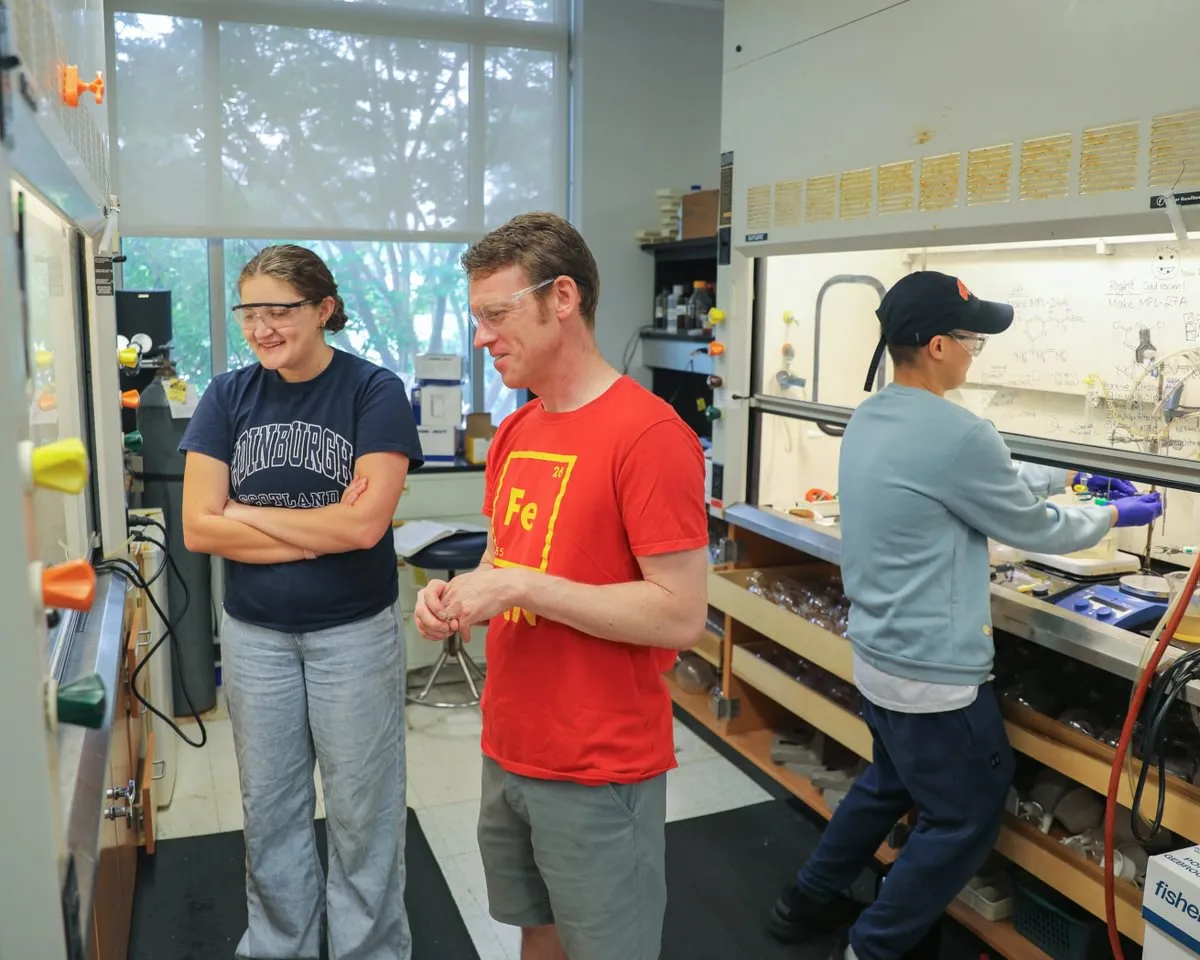 prof and students in chemistry lab