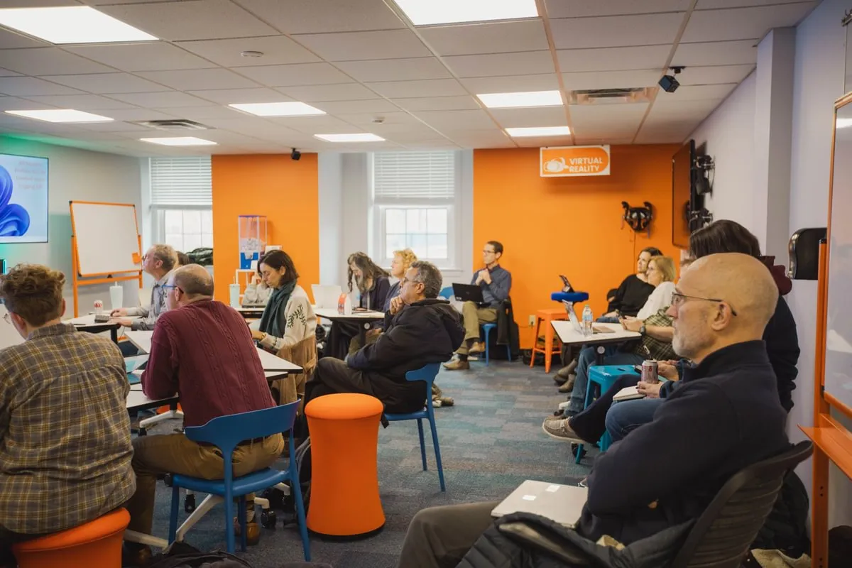 room full of faculty pay attention to presenter
