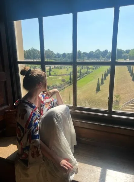 Colleen Bergmann ’25 looking out a window at Hampton Court Palace