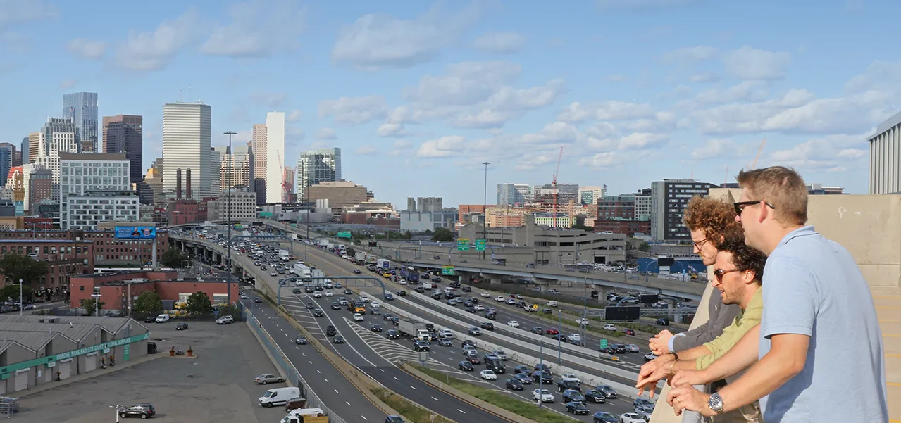 A group of students looks out at highway congestion in Boston.