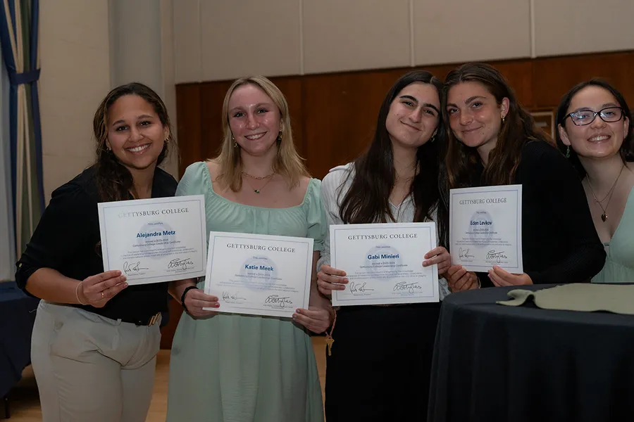 A group of students holding their certificates.