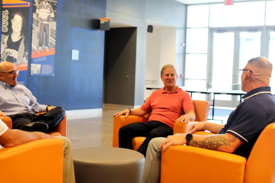 Bob Ortenzio ’79 meets with College President Bob Iuliano and the coaching staff from both wrestling programs inside the Jaeger Athletic Center..
