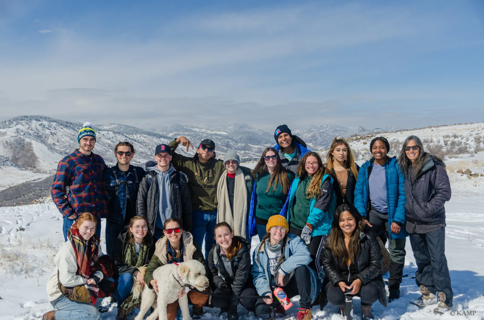 A photo of a group of students standing on a snow-covered hill.