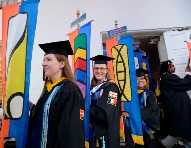 Graduates holding their departments banners