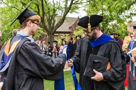 A graduate receives the stole of gratitude