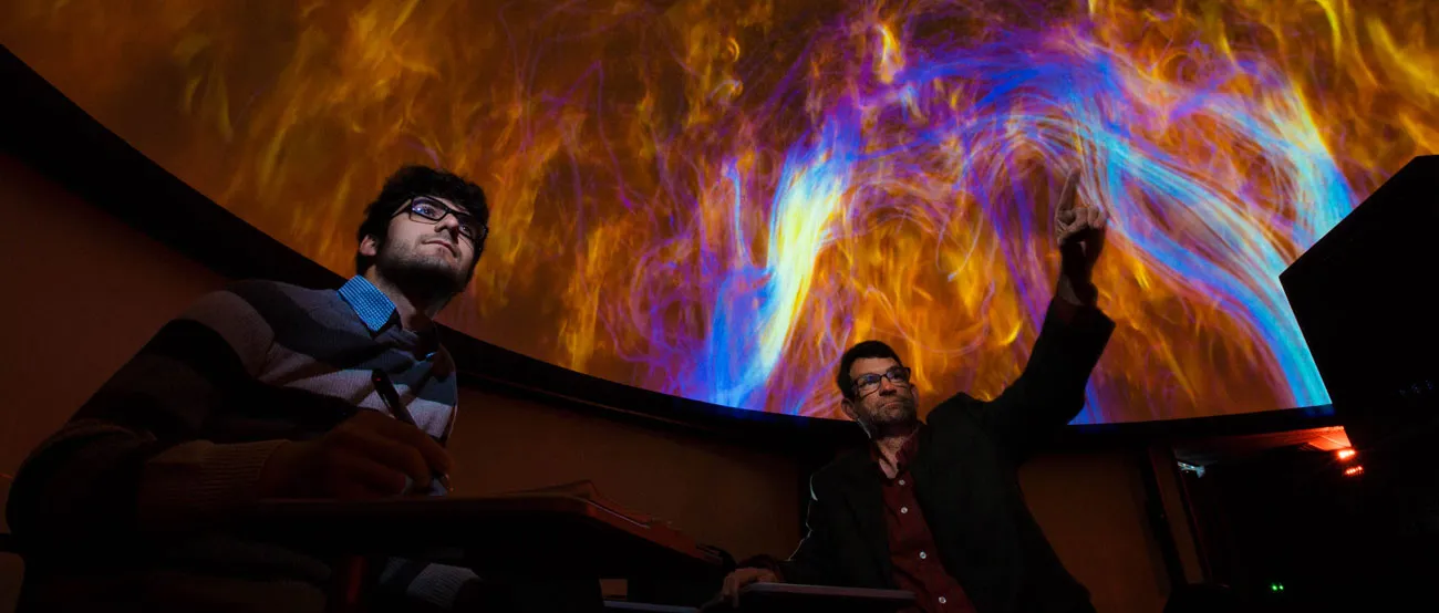 A student and faculty member at the Hatter Planetarium.