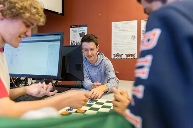 Students work in a classroom.