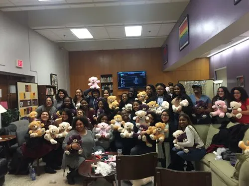 A group of people holding teddy bears