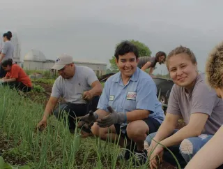 A group of students working in a garden.
