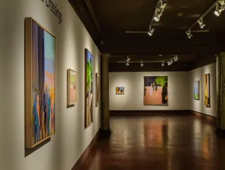 A photo of the interior of the Schmucker Art Gallery with paintings on the walls.