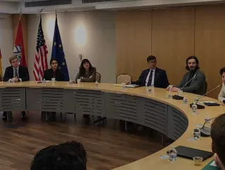 A group of people sitting around a circular table.