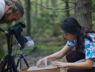 A student and faculty member doing research in the field.