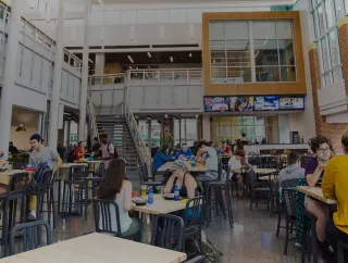 Students sit at the tables in the College Union Building.