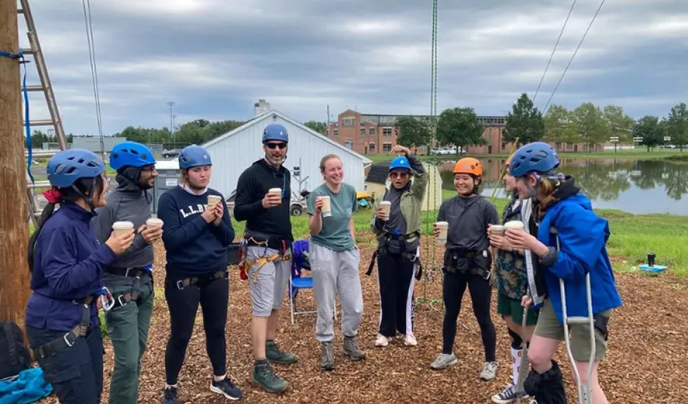 A team celebrates a successful adventure with drinks, camaraderie, and smiles.