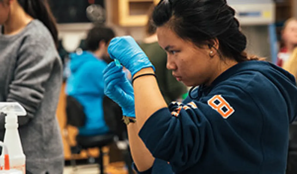 student examining something in bio lab