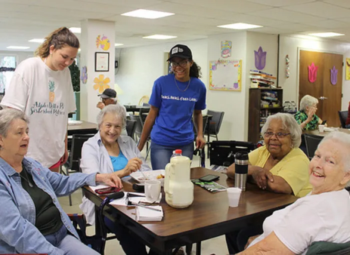 Two students greet a group of seniors at the Gettysburg Senior Center.