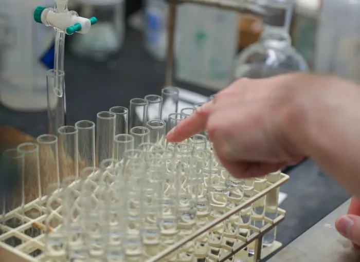 pointing at glassware in chem lab