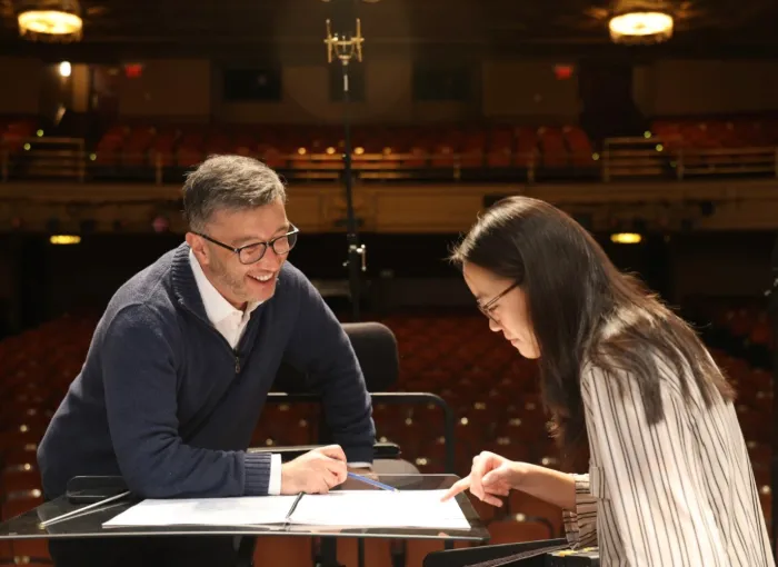 Music instruction happening on stage between prof and student