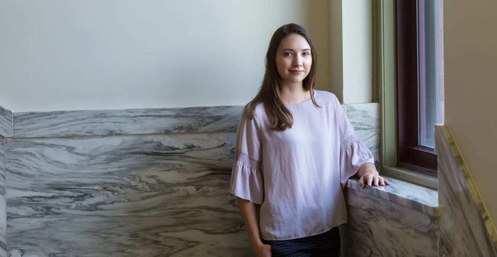 Haley Shultz standing in a hallway inside of Glatfelter Hall